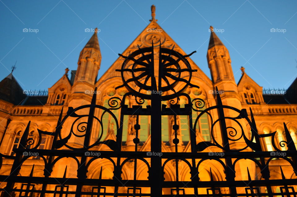 looking up. gate of the university at dusk