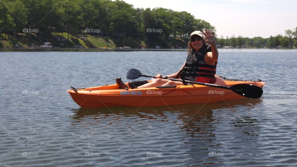 Young woman on a kayak at lake
