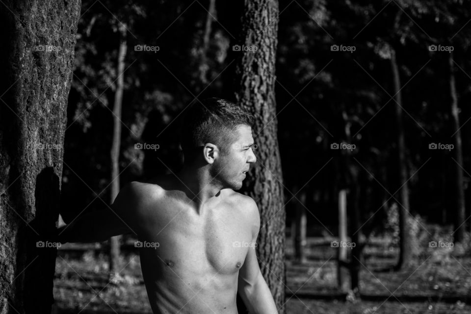 Man body street workout. Young boy working out in forest