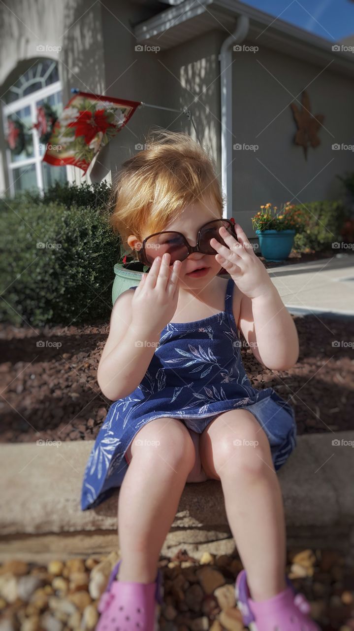 Small girl wearing sunglasses