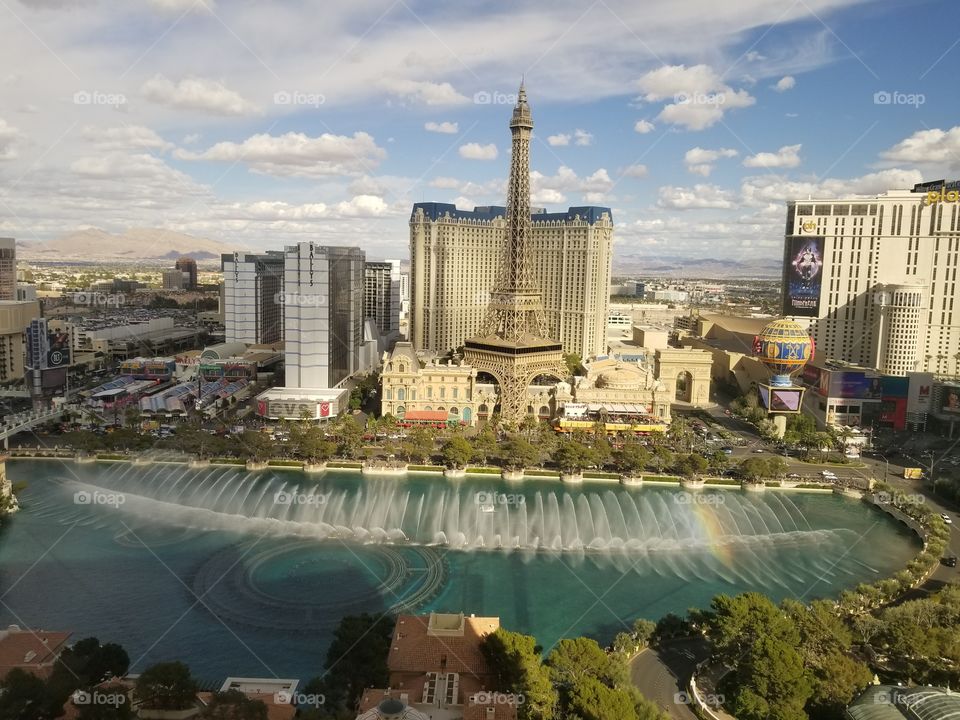 Las Vegas view of Paris hotel with Bellagio fountains and a rainbow