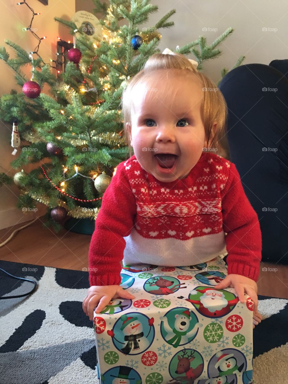 Baby excited to open a Christmas gift