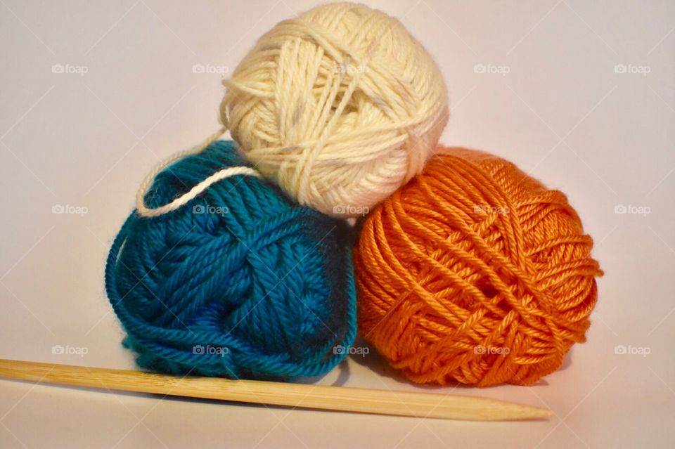 Ball of wools with knitting needle