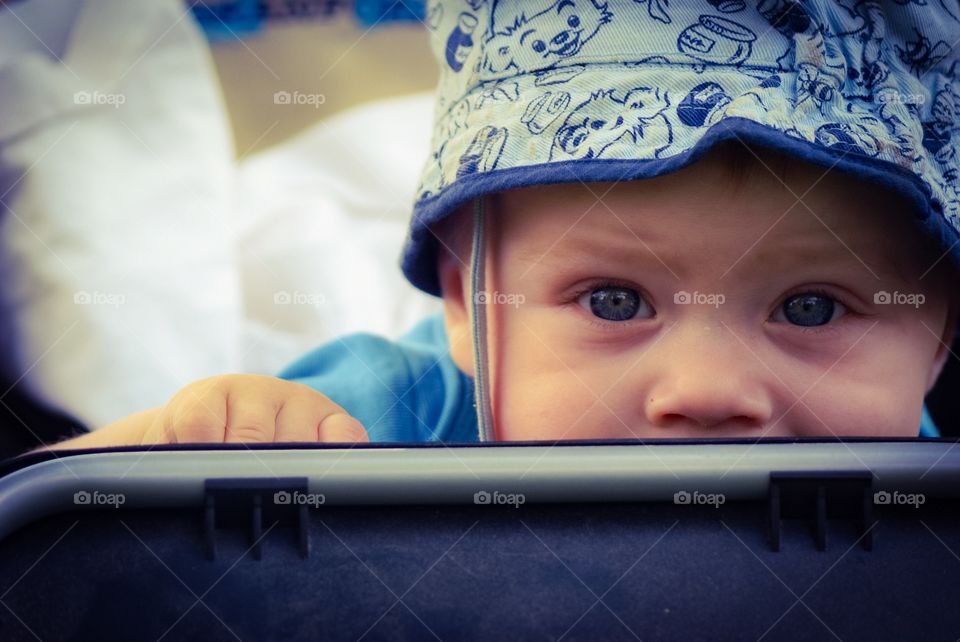 Cute baby. Baby boy sitting in a stroller