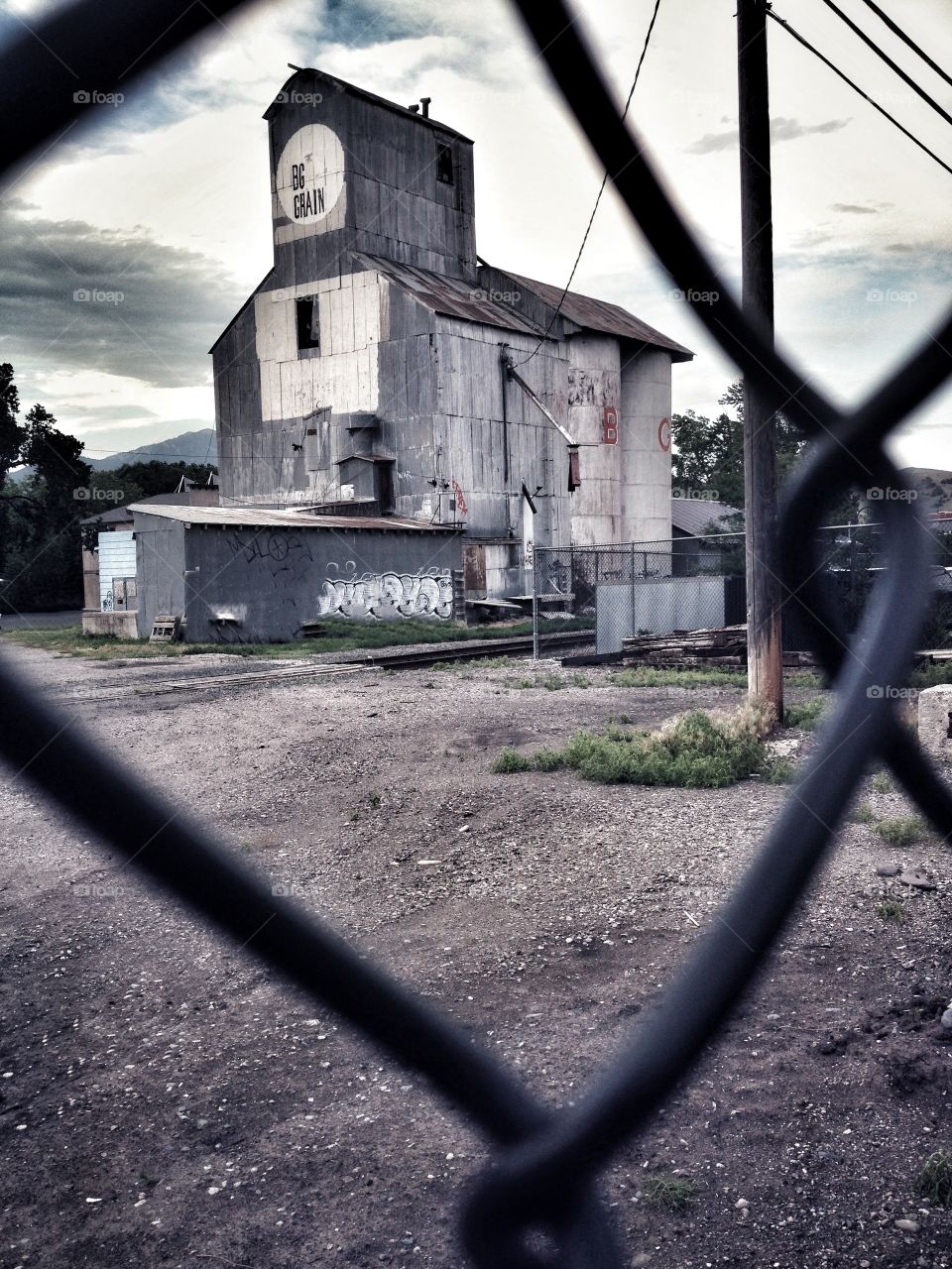 Old Grainery - viewer through a chain link fence
