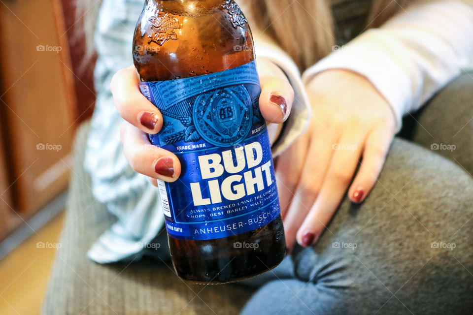 Bud Light- holding a bud light.