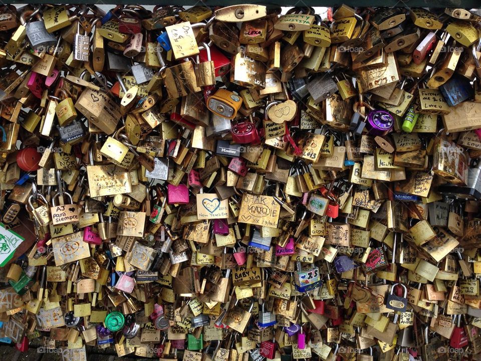 Love padlocks/ locks on the bridge Pont des Arts, across the river Seine in Paris, France