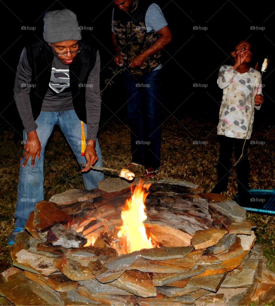 Friends having marshmallow at the campfire