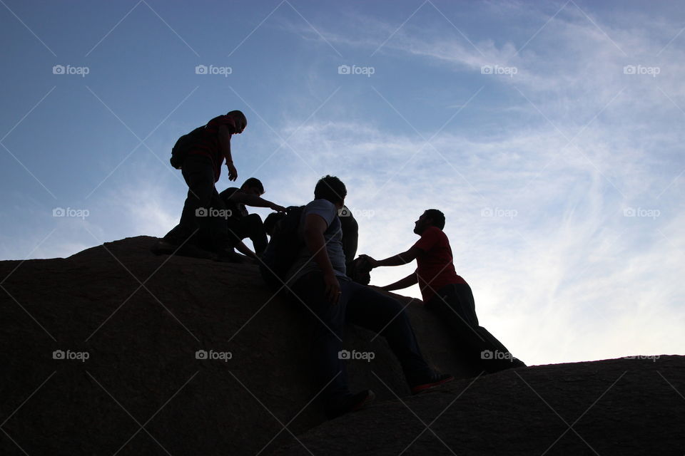 People hiking in summer, rock climbing