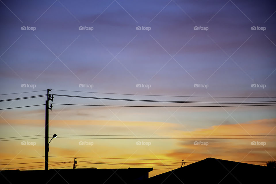 Beautiful light of Sunset with clouds in the sky reflection behind the building.