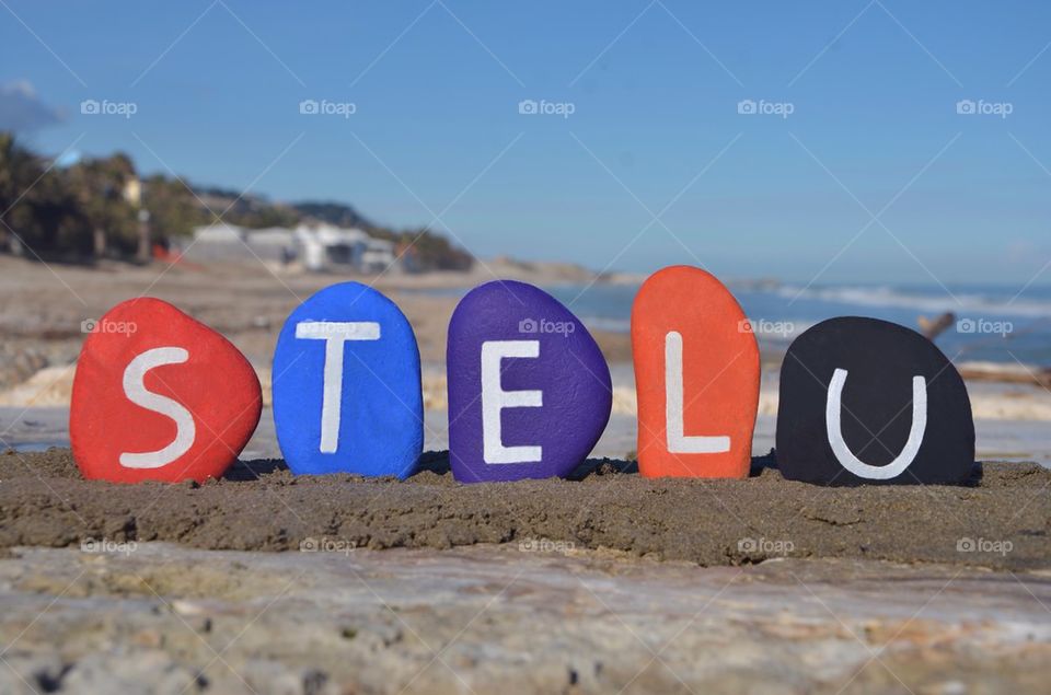 Stelu, romanian male name on colourful stones