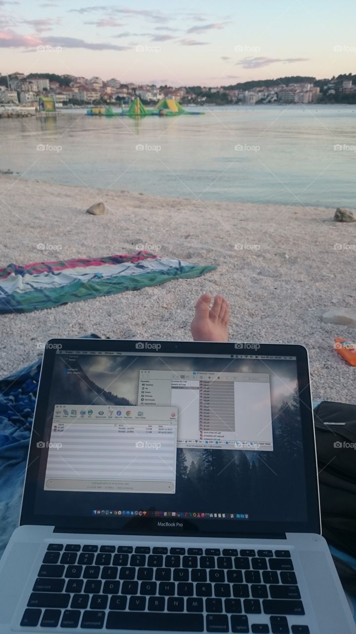 me working on vacation. me on the beach working some freelance jobs