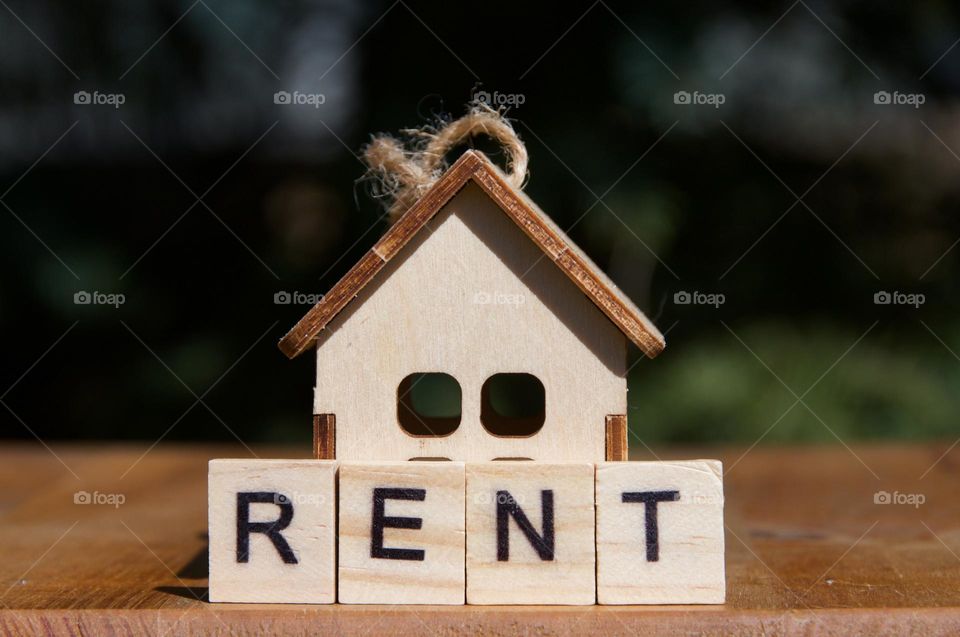 A toy wooden house and the inscription for rent. Real estate concept. Apartment. House. Housing 
