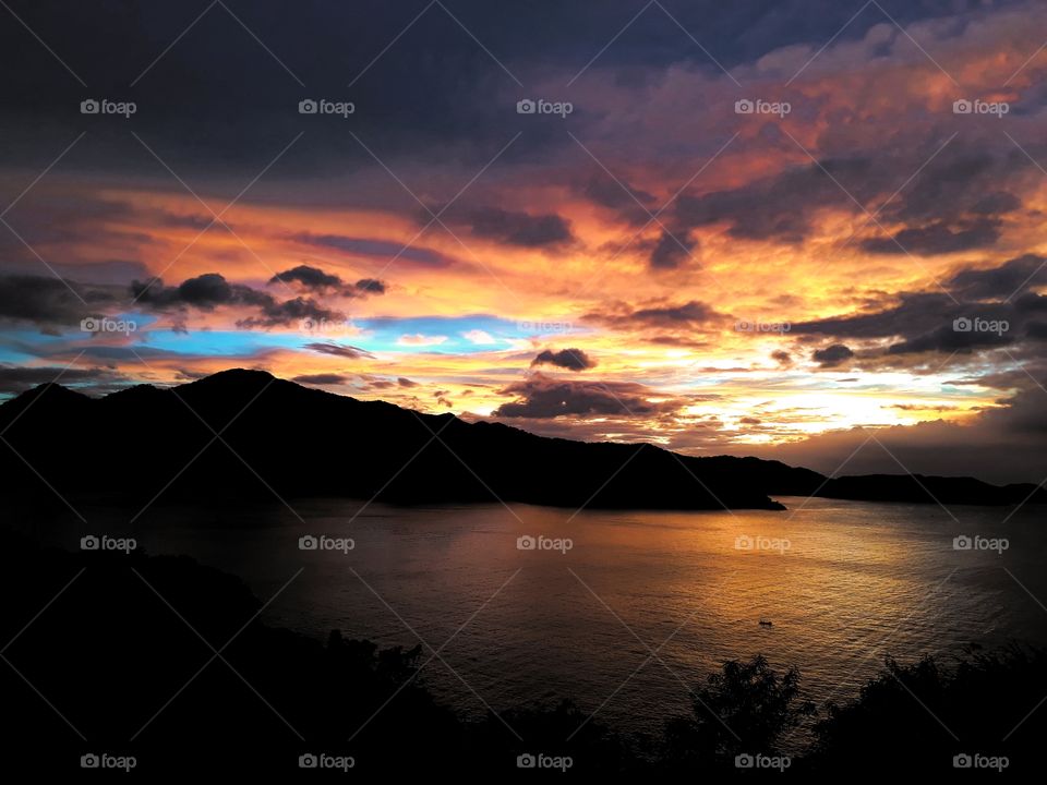 Overlooking the sky, mountain and sea at sunset