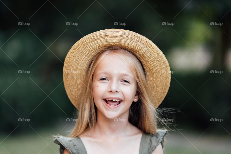 Candid portrait of happy little Caucasian girl with blonde hair 