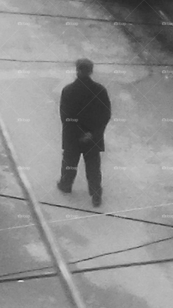 Man walking on grey morning