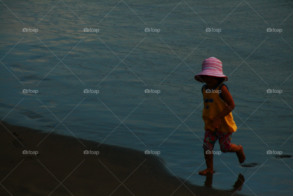 beach girl shadow water by bradman