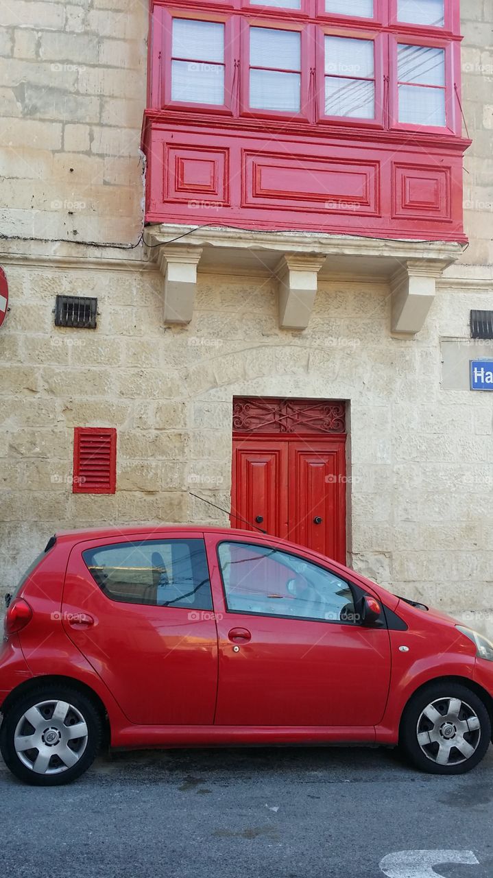 Colour coordinated car, door and windows.  House in village in Malta