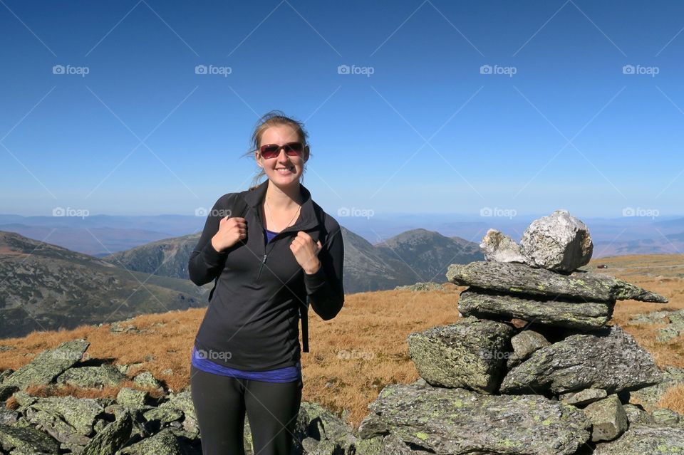 Woman  hiking smiling in  the mountains 