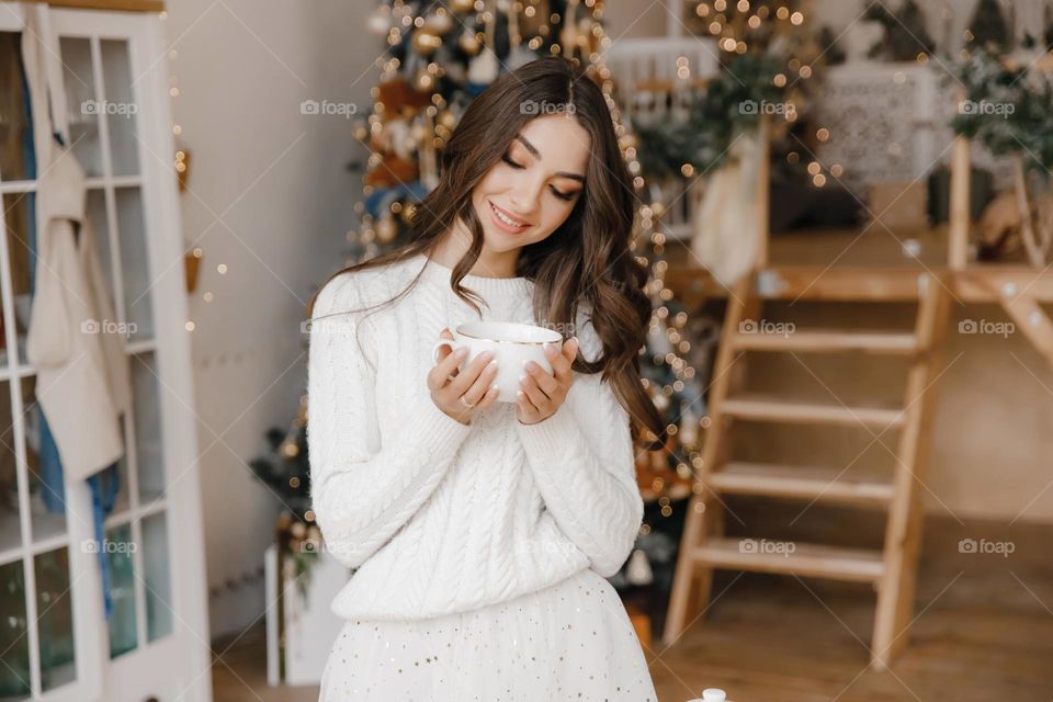 Beautiful girl in white clothes take a cup of coffee