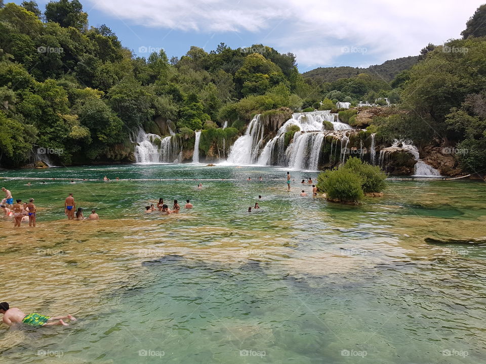 Swimmers on a sunny summer day, at Kirka Waterfalls, in Croatia