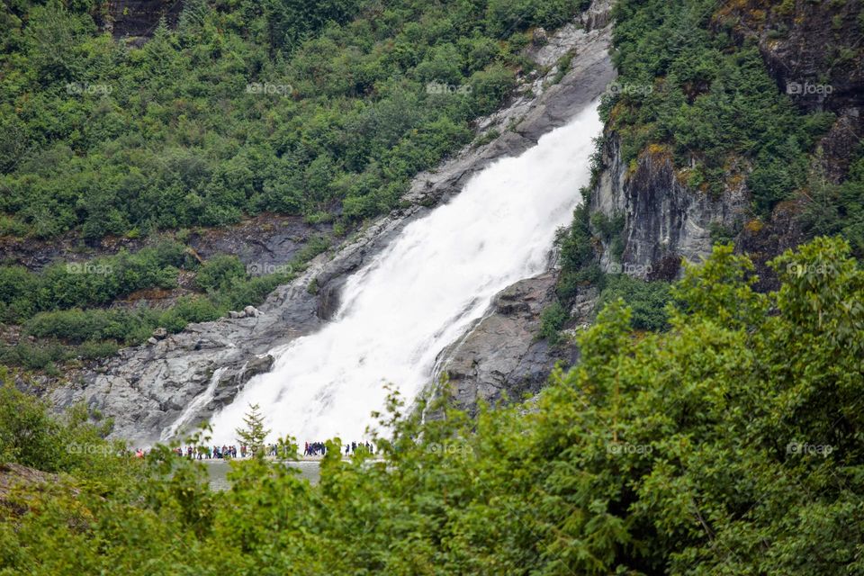 Nugget Falls on the outskirts of Juneau Alaska features massive amounts of water as a result of glacier runoff