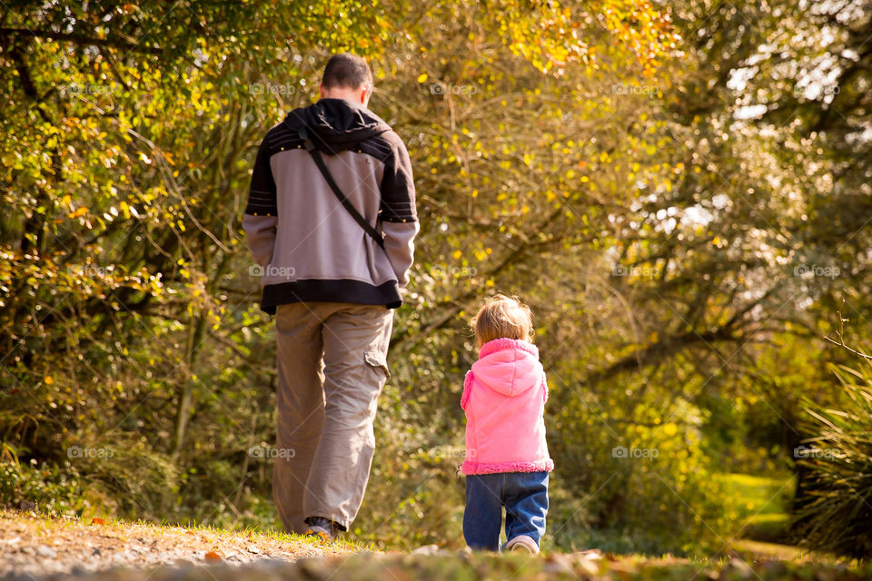 Love this image of father and daughter walking down the farm road. Image of dad and girl walking under trees in autumn