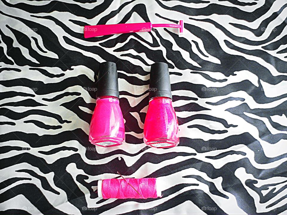 Hot pink objects on zebra print background
