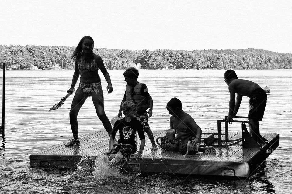 “Rock the Float” Cousins frolic on a float in the lake on a sweltering summer day.