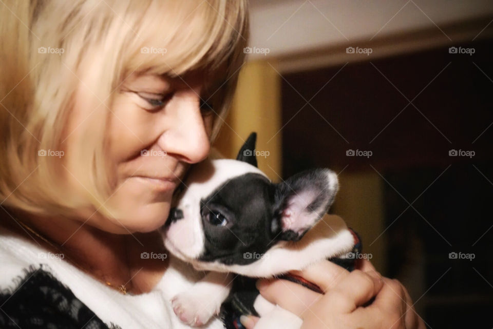 Woman and French bulldog puppy