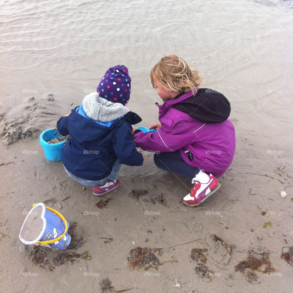 Playing in the sand. Visiting the beach early summer