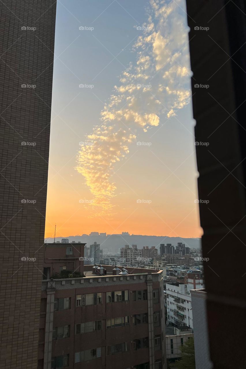 Cloud river between buildings 