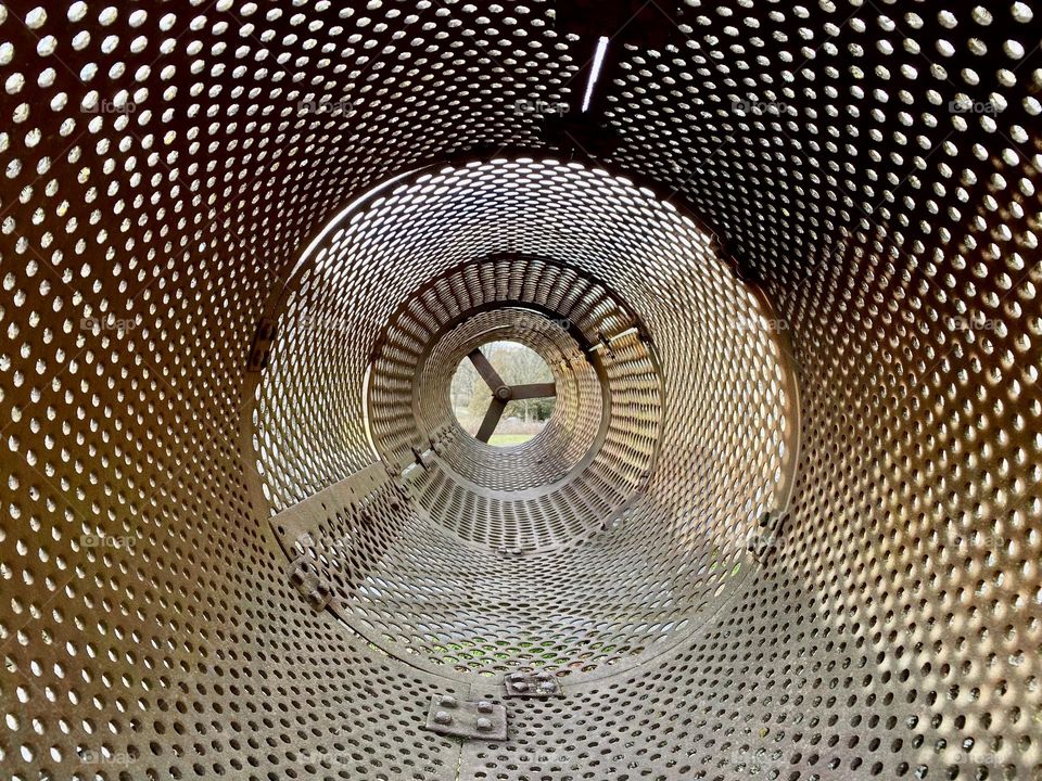 Holes in a metal tube used to sort ore by size