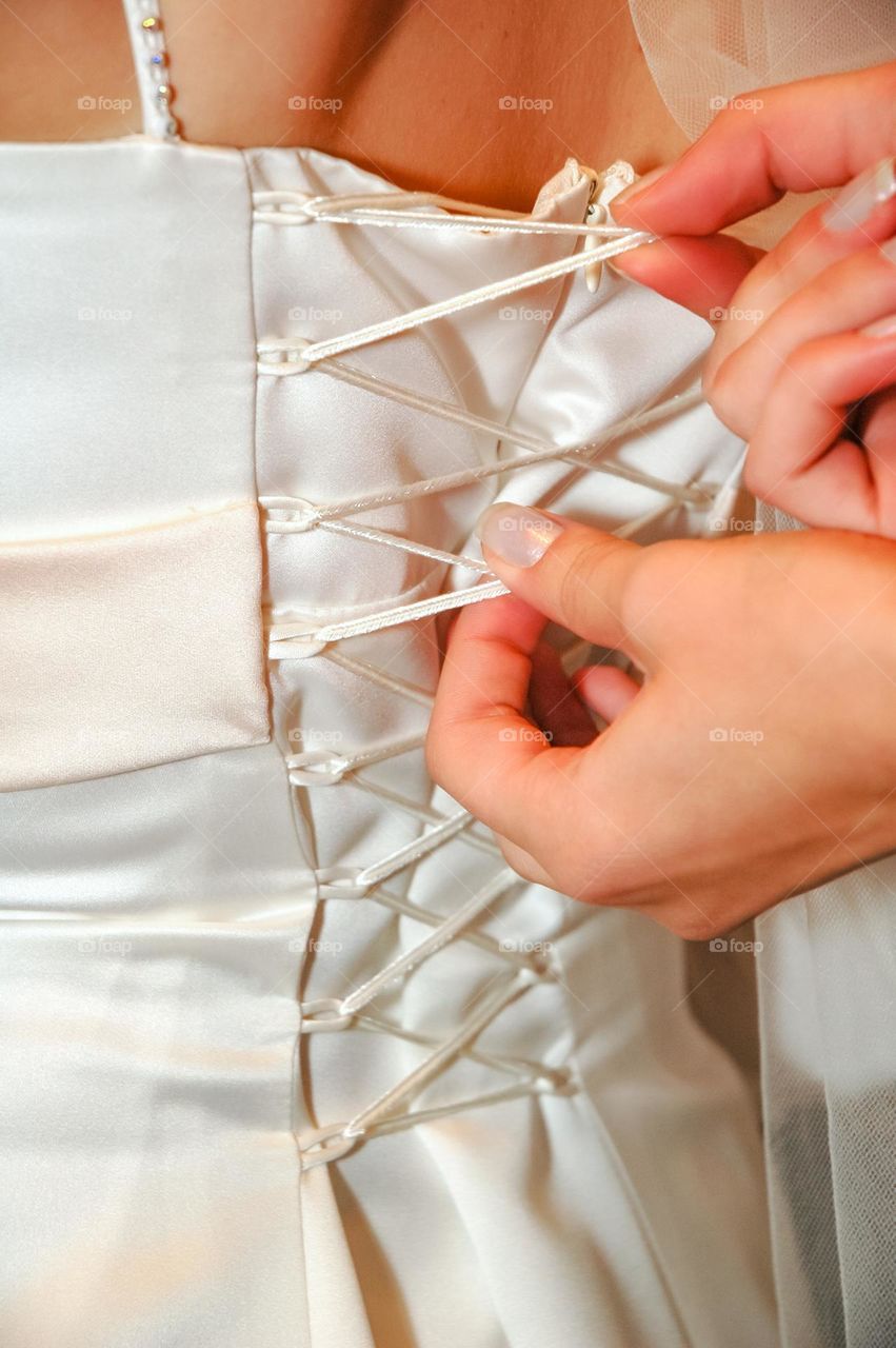 Preparing the bride's white dress for the wedding