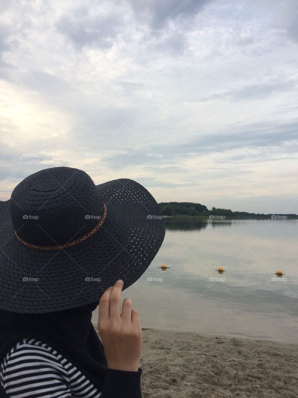 Girl on the beach with a hat