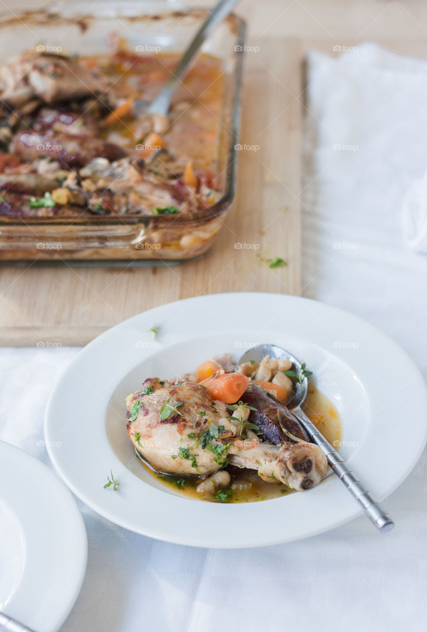 Cassoulet, French cuisine. Plate with Cassoulet, French stew with chicken, white beans and sausages. Traditional dish from France. Comfort food.