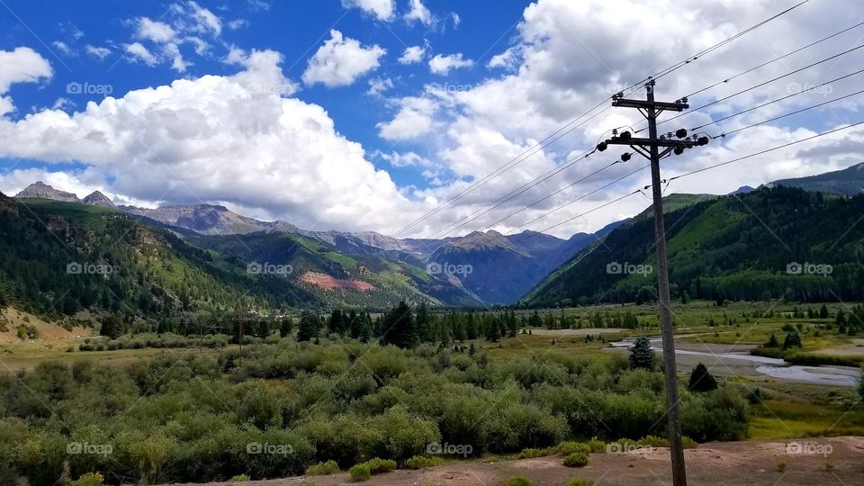 Beautiful Rocky Mountain Valley with River Running Through it Under a Bright Blue Sky in Telluride, Colorado