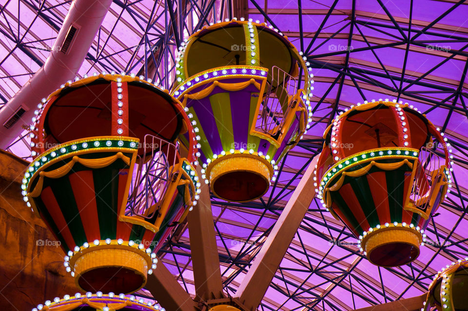 Ferris wheel against purple background with purple light
