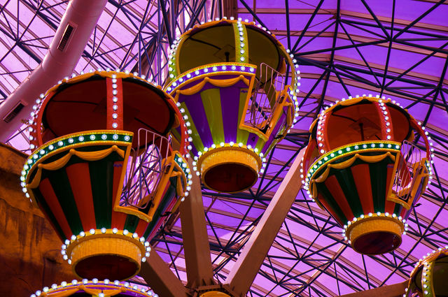 Ferris wheel against purple background with purple light