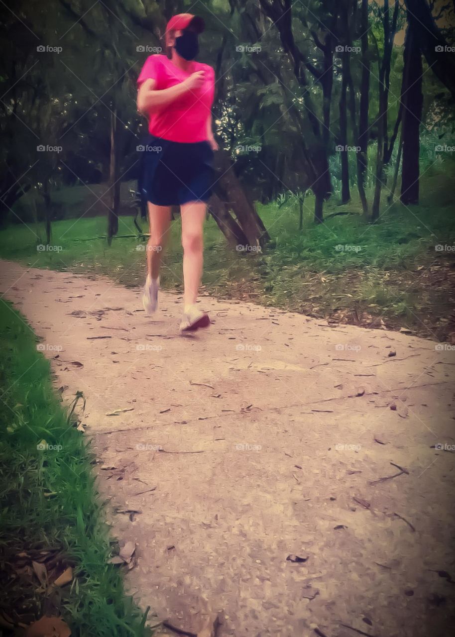 Woman jogging in the park after working hours. Doing physical activity has benefits for physical and mental health.