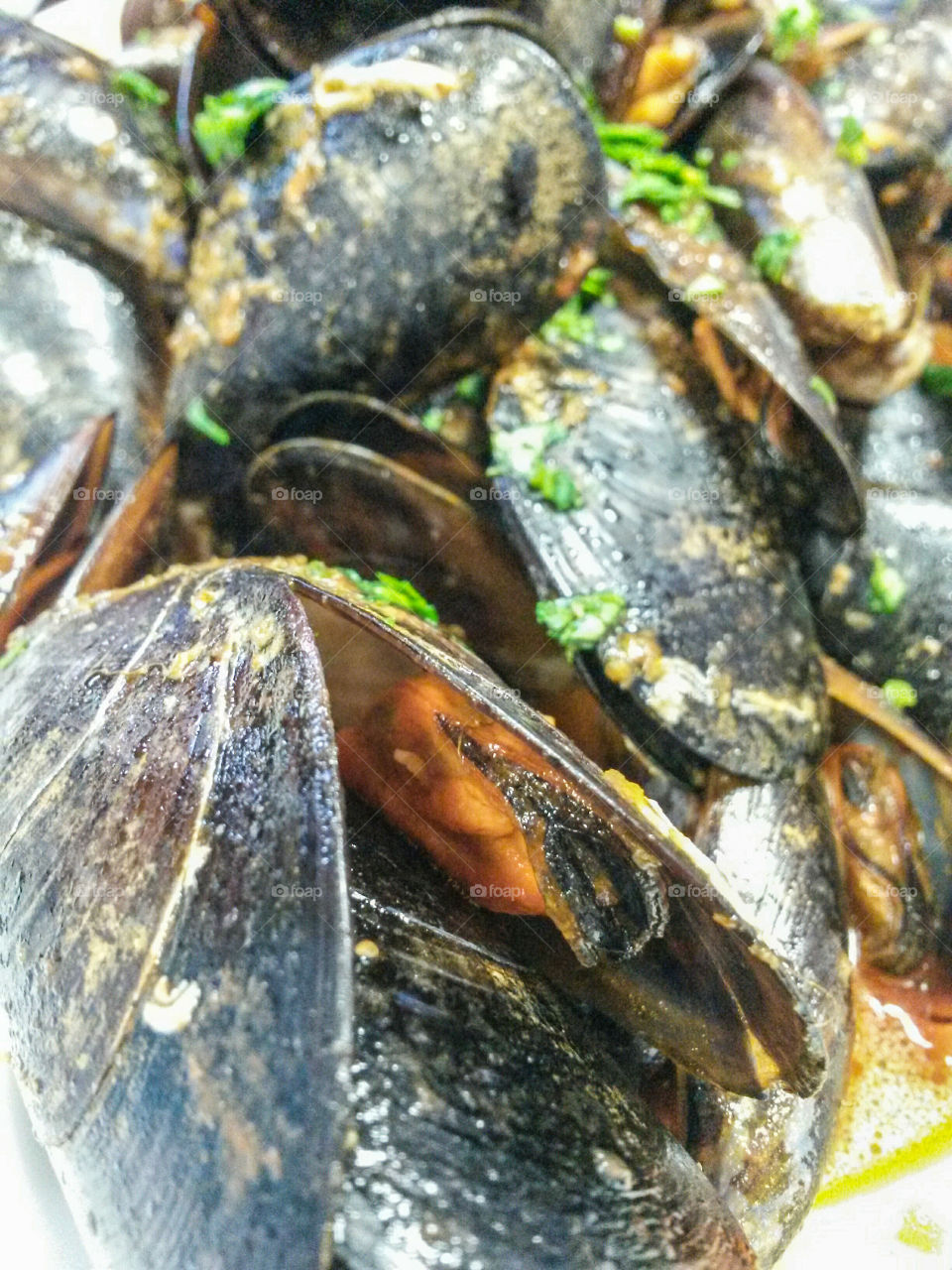 French cuisine: Close up of 'moules sautè avec pomme de terre'. mussels with tomato sauce