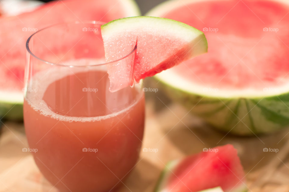 Home made juicing pink fresh watermelon with juice in glass and sliced  sweet seedless watermelon healthy refreshing drink background photography 