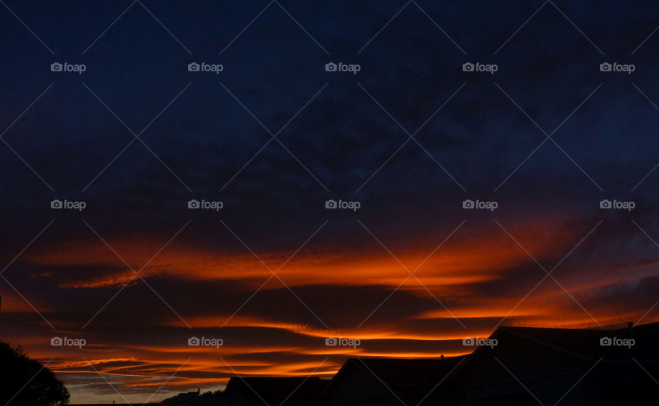 Dark red sunset with the stormy clouds 