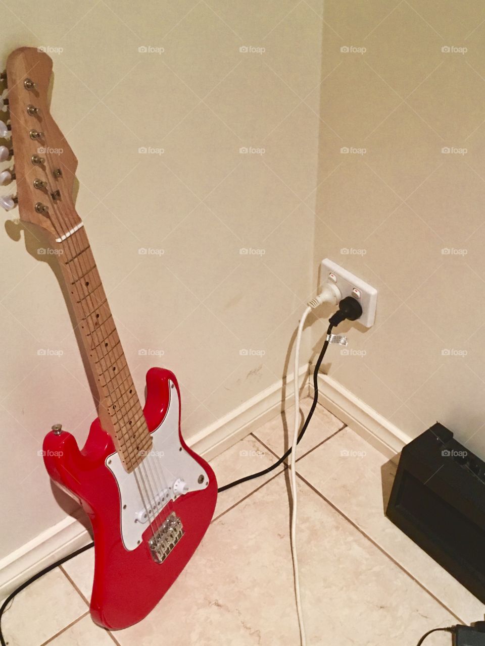 A Electric Guitar leaning against a wall