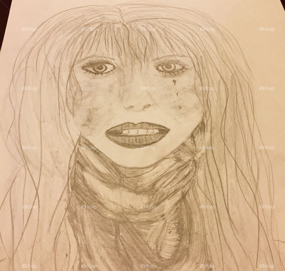 Drawing of a woman with tear on her face.