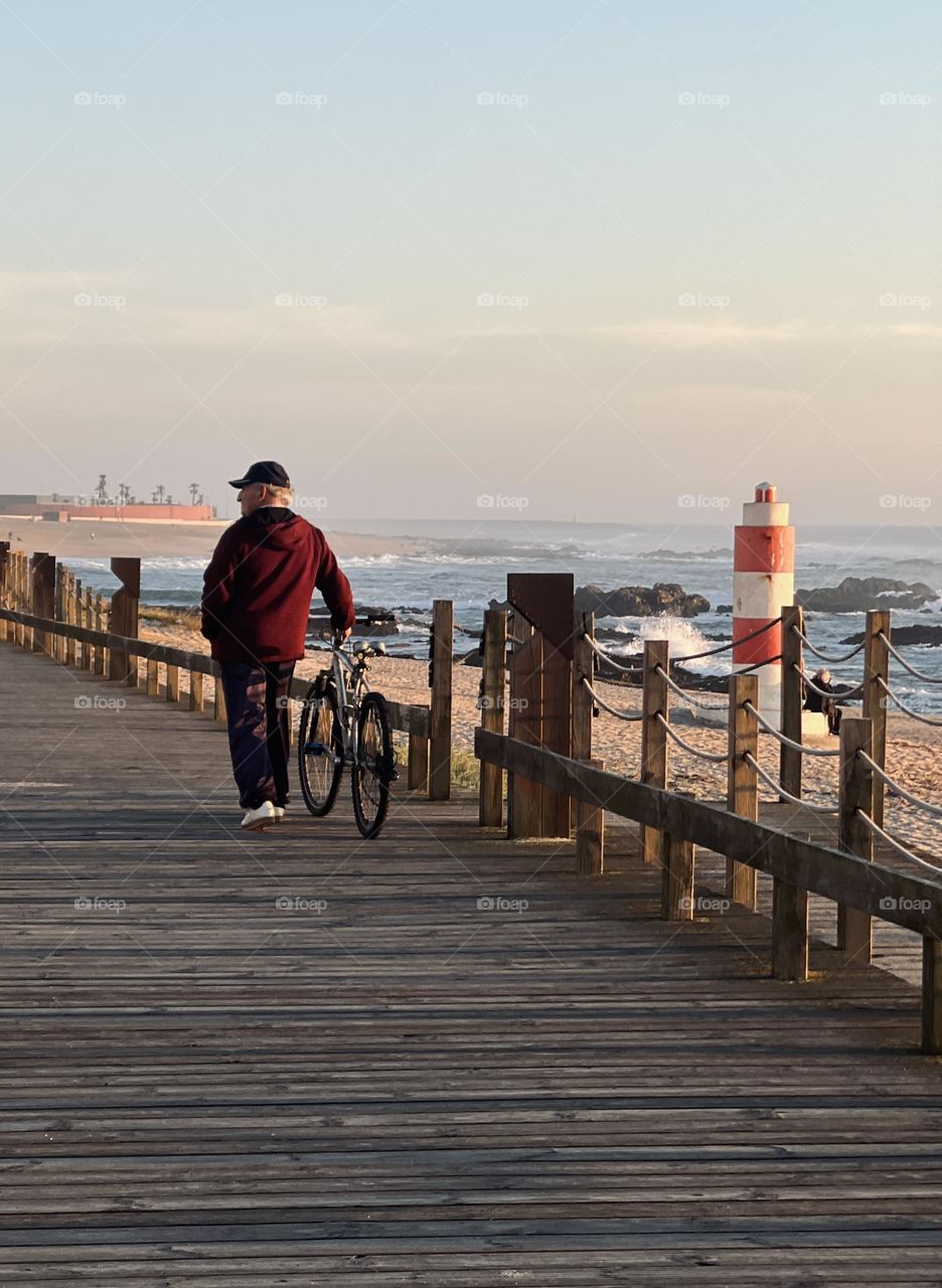 Man with bike by the beach