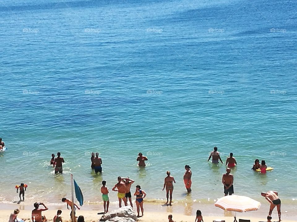 People by the sea in a beach.