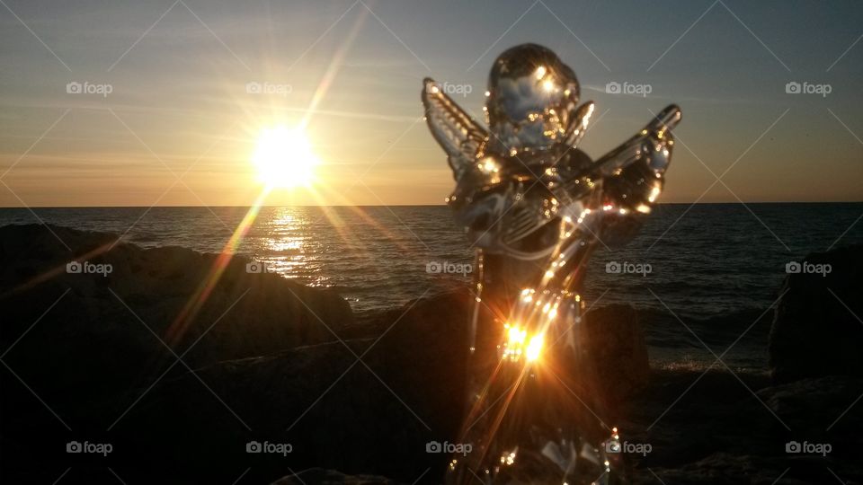 Angel at sunrise. . I took this glass angel to the beach at sunrise to honor a friend who passed away from cancer the previous day. I dedicated this image to him.