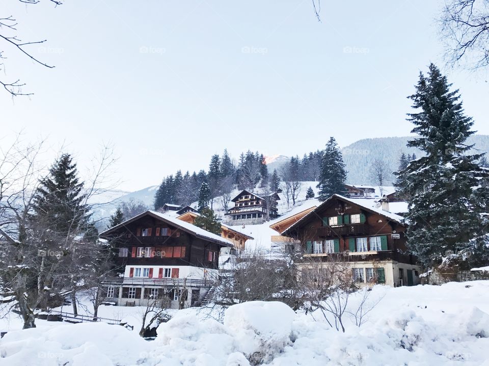 Wooden cottages in snow mountain, Switzerland 