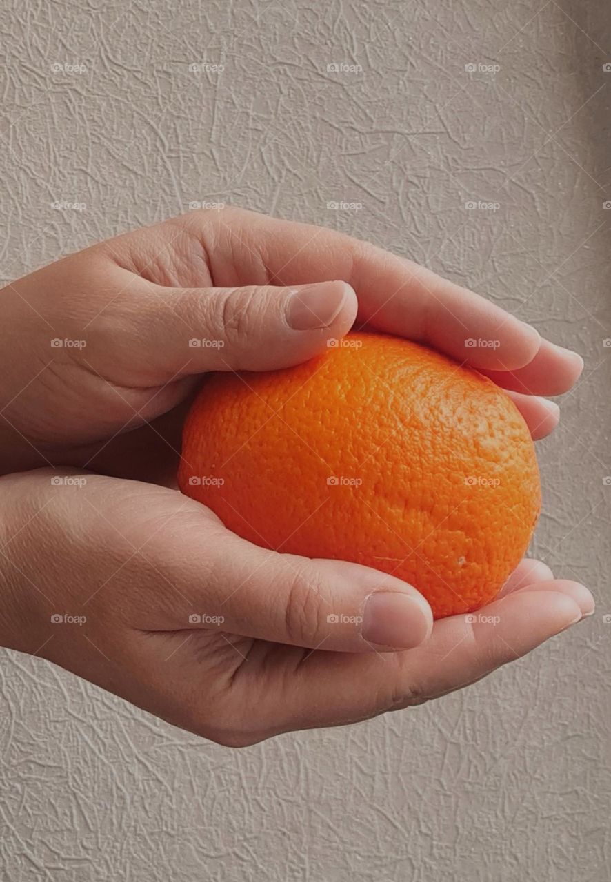 orange in hand